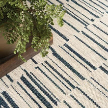 Cream runner rug with navy-blue vertical stripes and curved abstract line accents.