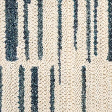 Cream rug texture with navy-blue vertical lines pattern, tightly framed.