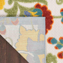 Indoor/outdoor area rug diagonal corner with ivory base and multicolor botanical pattern