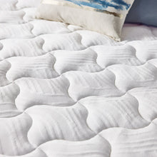 White quilted gel memory foam mattress topper surface with plush raised channels
