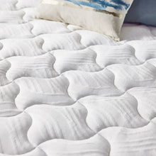 White quilted mattress topper surface with embossed comfort pattern