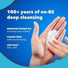 Hand with white face cleanser foam, fingers outstretched