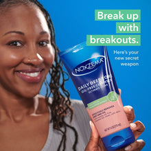 Face wash tube held in hand beside smiling person’s face