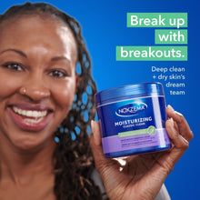 Moisturizing facial cleanser jar held near smiling face