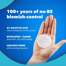 Salicylic acid acne treatment pad held in a hand, round white pad