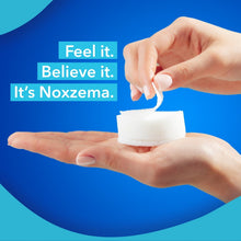 White round pad lifted from a hand with the pad held on fingertips