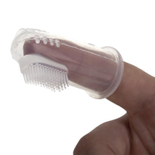 Nuby oral massage tool with clear cover and textured bristle head, held in hand