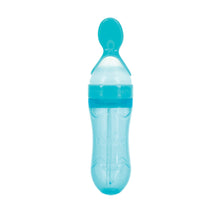 Teal silicone baby squeeze feeder bottle with cap and clear body