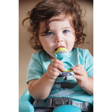 Infant using a Nuby soft foods feeder, blue and lime with clear silicone tip