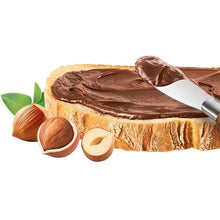 Hazelnut cocoa spread topping on cake with hazelnuts and chocolate drizzle