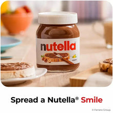 Nutella hazelnut spread jar on table with bread slice and pastries, white lid