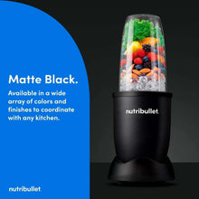 Matte black personal blender with clear blending jar filled with fruit