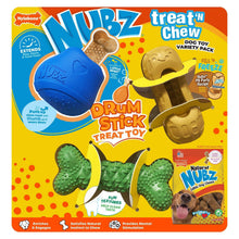 Dog chew toy variety pack with blue drum stick, green bone, and tan shell-shaped pieces