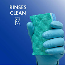 Green-and-blue scrunge sponge held in a hand for cleaning