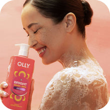 OLLY body wash bottle with pump, red label for Bright citrus currant, with lathered foam