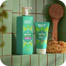 OLLY Revive body scrub bottles on shelf with wooden body brush and sponge