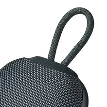 Mini rugged Bluetooth speaker top view with carry handle, dark gray woven fabric.