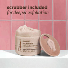 Foaming body scrub jar with included beige scrubber brush for exfoliation