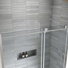 Sliding shower door with clear glass panel and horizontal brushed metal handle