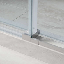 Lower track of frameless sliding shower door with clear glass panel and seal