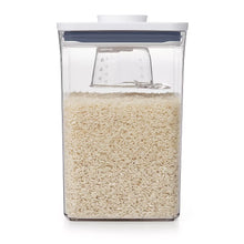 Rice measuring cup insert shown inside a clear container filled with rice