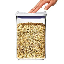 OXO POP container filled with oats/rye grains with lid being pressed shut