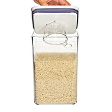 OXO POP container open with grains inside and clear scoop resting under the lid