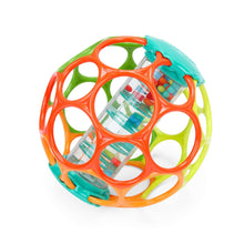Rainbow rattle ball with clear cylindrical inserts inside orange, green, and teal rings