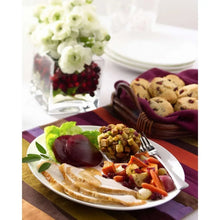 Jellied cranberry sauce with fruit pieces served on crackers on a plate