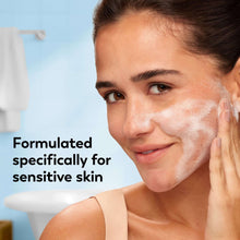 Foaming facial cleanser lather on face, hands supporting cheeks