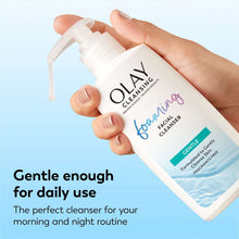 Olay foaming facial cleanser pump bottle held in hand, gentle label