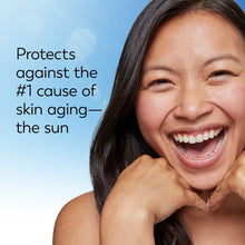 Smiling woman holding an Olay Complete SPF 30 lightweight lotion bottle