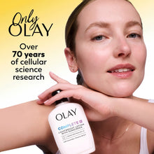 Woman with Olay Complete SPF 30 lightweight lotion bottle for sensitive skin