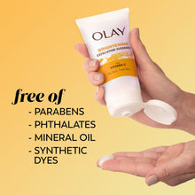 Olay brightening exfoliating cleanser tube in hands; free of parabens, phthalates