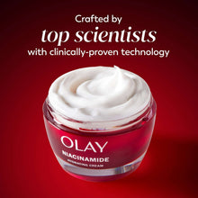 Red niacinamide face cream jar with white cream on top, hydrating moisturizer