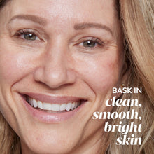 Detoxifying pore scrub face wash ad with close-up of woman’s skin and bright smile