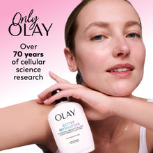 Person wearing Olay Active Hydrating lotion, holding the small bottle near shoulder