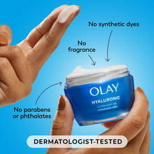 Olay hyaluronic ultralight gel jar held in hands, white cream on fingers