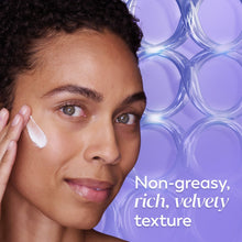Face cream being applied: white moisturizer on cheek with smooth skin