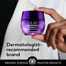 Olay Regenerist Retinol 24 night repairing cream jar held in hand, purple glass.