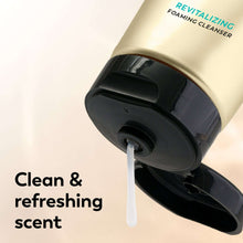 Olay foaming face wash dispenser releasing white foam, gold tube close-up