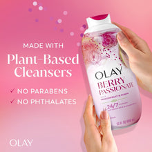 Hands holding Olay Berry Passionate body wash bottle, plant-based cleansers