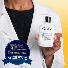 Olay Complete+ facial moisturizer with sunscreen SPF 40 in a white lab-coat hand