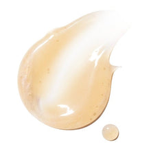 Glossy light-orange lotion smear with drop texture