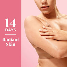 Woman applying body wash foam to shoulder, hands and lather visible
