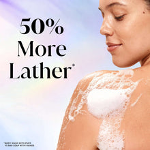 Woman lathering skin with creamy body wash foam, bottle not visible