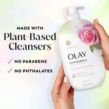 Olay Fresh Radiance body wash bottle held in a hand, showing pump