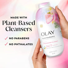 Olay Fresh Radiance Strawberry & Mint body wash bottle held in hand