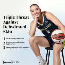 Athlete holding Olay Victory Vibes Vanilla body wash bottle, blue pump on white base