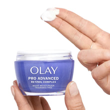 Olay Pro Advanced Retinol night moisturizer jar with cream on fingertip
